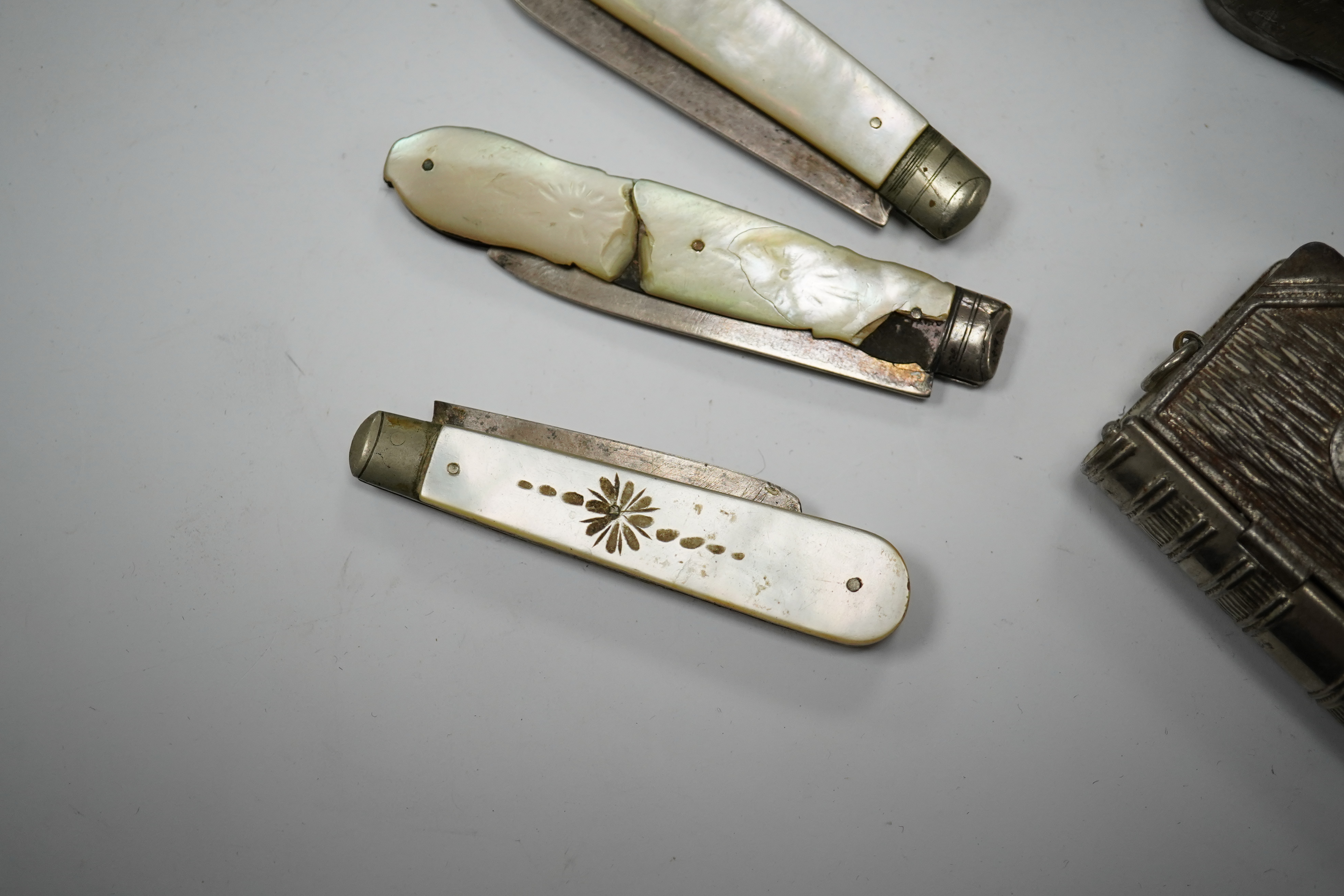 Four mother-of-pearl penknives, two vesta cases and a treen shoe, treen shoe 10cm long. Condition - fair